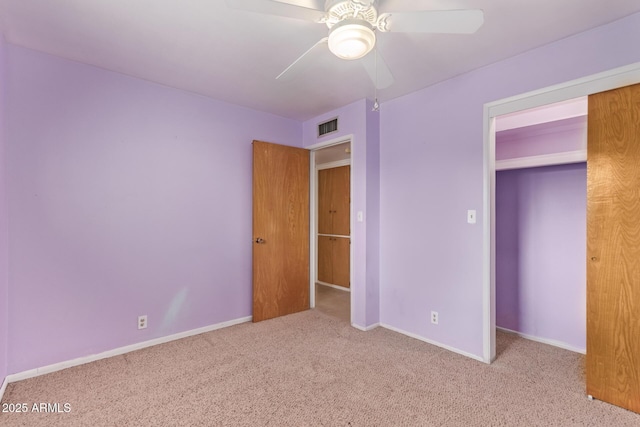unfurnished bedroom featuring baseboards, visible vents, carpet flooring, and a ceiling fan