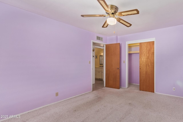 unfurnished bedroom with carpet, baseboards, ceiling fan, visible vents, and a closet