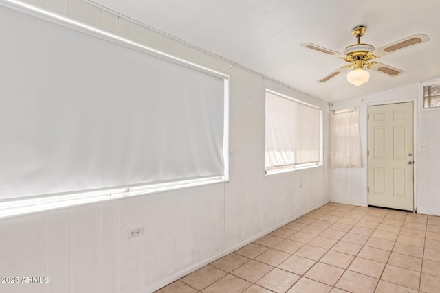 empty room with light tile patterned floors, visible vents, and ceiling fan