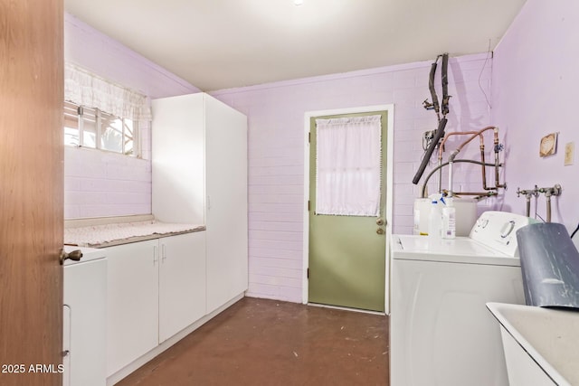 laundry area featuring water heater, cabinet space, a sink, and washer and dryer