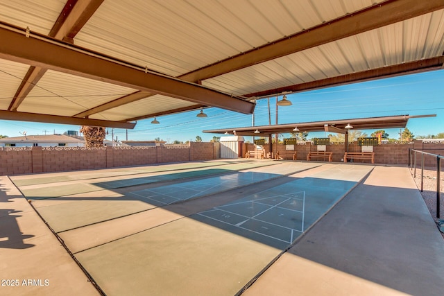 view of swimming pool featuring fence and shuffleboard