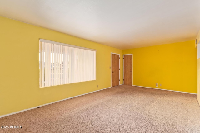 carpeted spare room with baseboards