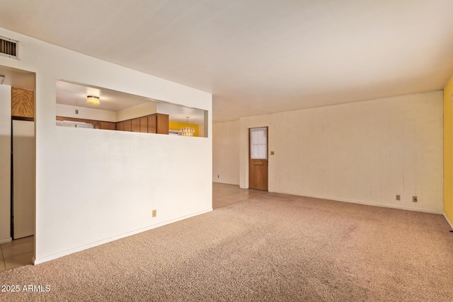unfurnished room with visible vents and carpet