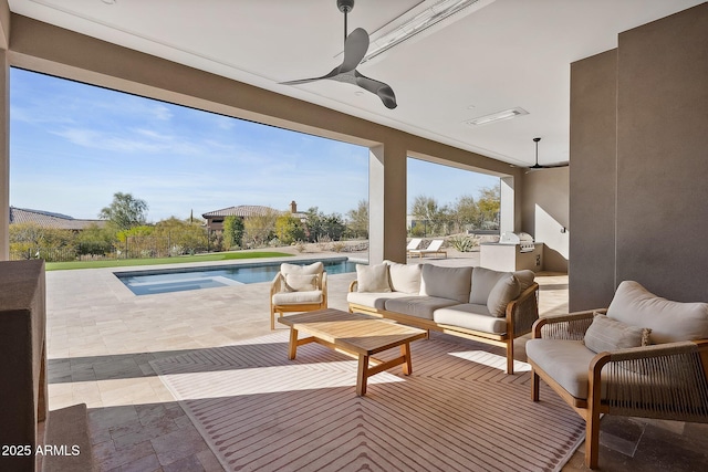 view of patio featuring outdoor lounge area, exterior kitchen, an outdoor pool, and ceiling fan