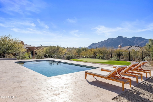 view of pool with a fenced in pool, a mountain view, a patio, and fence