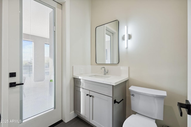 half bath featuring toilet and vanity