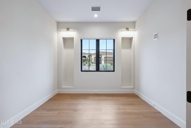 spare room with recessed lighting, baseboards, visible vents, and light wood-type flooring