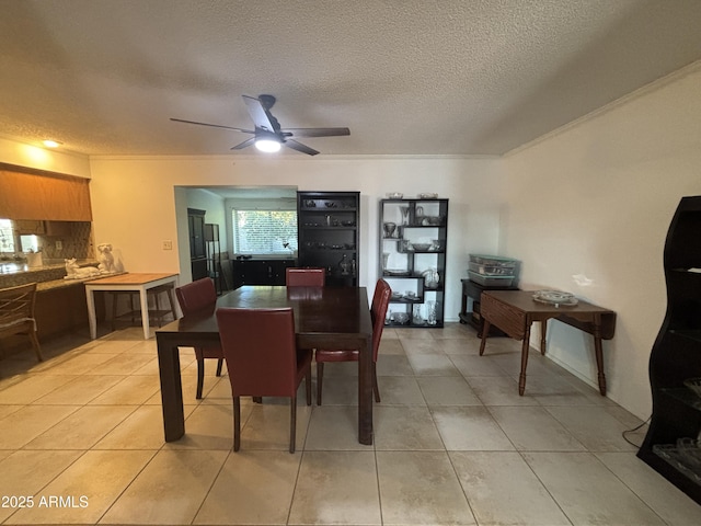 tiled dining area featuring a textured ceiling and ceiling fan