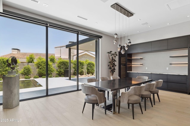 6908 E Cactus Wren Rd, Paradise Valley, AZ 85253 - dining space with light wood-style floors and expansive windows