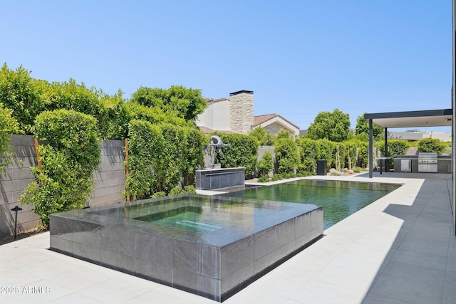 6908 E Cactus Wren Rd, Paradise Valley, AZ 85253 - view of swimming pool featuring an outdoor kitchen, an in-ground hot tub, and a patio