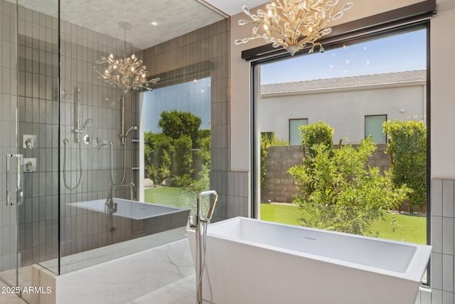 6908 E Cactus Wren Rd, Paradise Valley, AZ 85253 - full bath featuring a chandelier, a soaking tub, and a stall shower