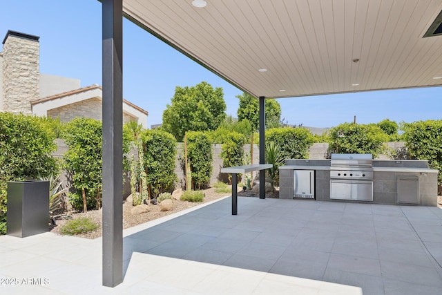 6908 E Cactus Wren Rd, Paradise Valley, AZ 85253 - fenced backyard with an outdoor kitchen and a patio area