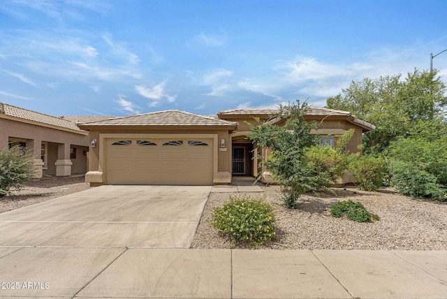 4404 W Ellis St, Laveen, AZ 85339 - view of front facade with stucco siding, a garage, concrete driveway, and a tile roof