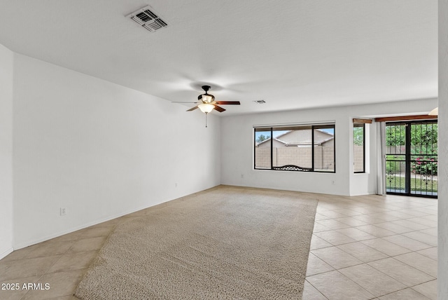 4404 W Ellis St, Laveen, AZ 85339 - spare room with plenty of natural light, a ceiling fan, and light tile patterned flooring