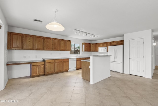 4404 W Ellis St, Laveen, AZ 85339 - kitchen featuring white appliances, brown cabinets, a sink, light countertops, and a kitchen island