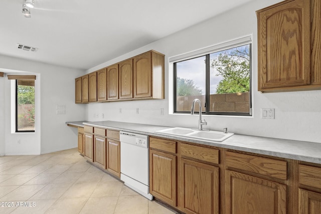 4404 W Ellis St, Laveen, AZ 85339 - kitchen with white dishwasher, a sink, brown cabinets, and light countertops