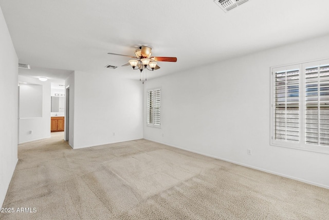 4404 W Ellis St, Laveen, AZ 85339 - spare room with ceiling fan, light colored carpet, and baseboards