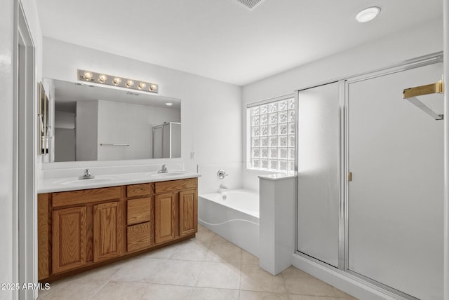 4404 W Ellis St, Laveen, AZ 85339 - bathroom with a garden tub, double vanity, a shower stall, and tile patterned flooring