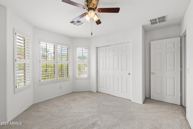 4404 W Ellis St, Laveen, AZ 85339 - unfurnished bedroom with carpet, multiple windows, a closet, and a ceiling fan