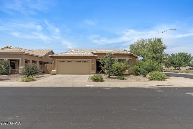 4404 W Ellis St, Laveen, AZ 85339 - view of front of house with stucco siding, an attached garage, and concrete driveway