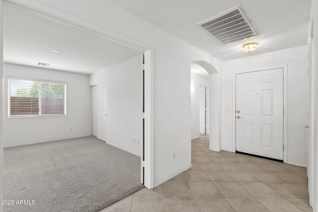 4404 W Ellis St, Laveen, AZ 85339 - entryway with arched walkways, light tile patterned flooring, baseboards, and light carpet