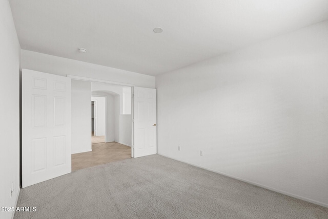 4404 W Ellis St, Laveen, AZ 85339 - carpeted spare room with arched walkways
