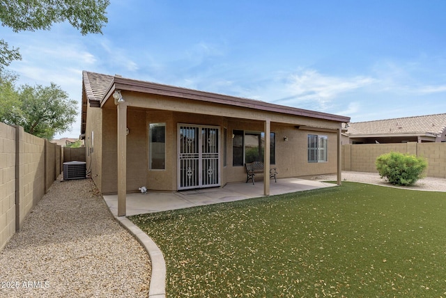 4404 W Ellis St, Laveen, AZ 85339 - rear view of house with central AC, stucco siding, a fenced backyard, and a patio area