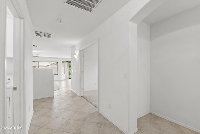 4404 W Ellis St, Laveen, AZ 85339 - corridor with light tile patterned floors, arched walkways, and baseboards
