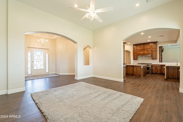 entrance foyer featuring ceiling fan with notable chandelier, dark hardwood / wood-style floors, and sink