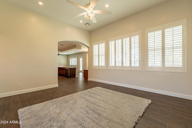 unfurnished room featuring dark hardwood / wood-style floors, ceiling fan, and sink