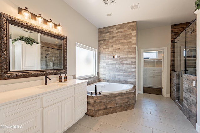 bathroom featuring tile patterned floors, vanity, and independent shower and bath