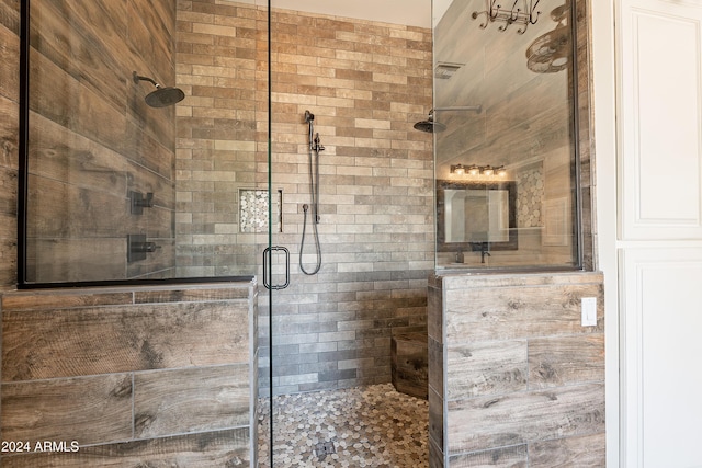 bathroom with a shower with door