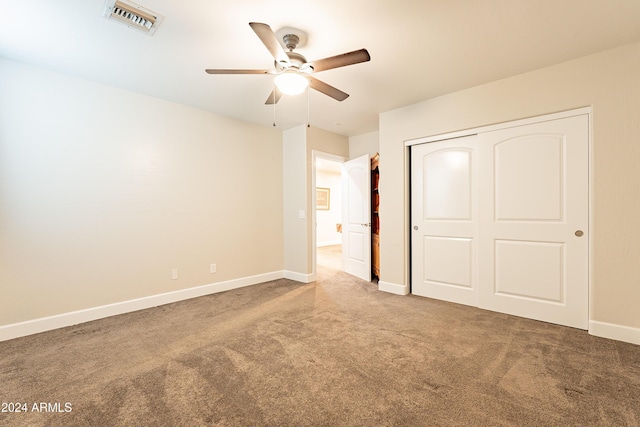 unfurnished bedroom featuring ceiling fan, a closet, and carpet floors