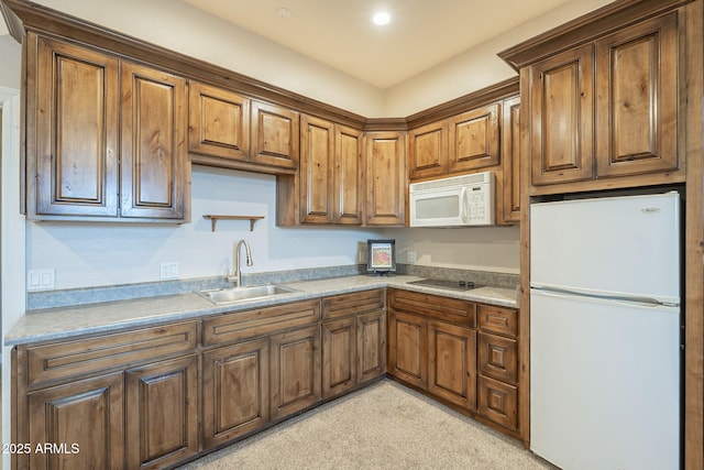 kitchen featuring white appliances and sink