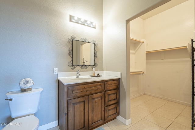 bathroom featuring tile patterned floors, vanity, and toilet