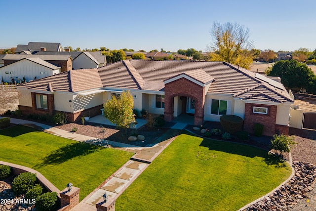 ranch-style home with a front yard