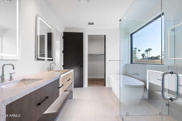 bathroom featuring separate shower and tub, tile patterned flooring, and vanity