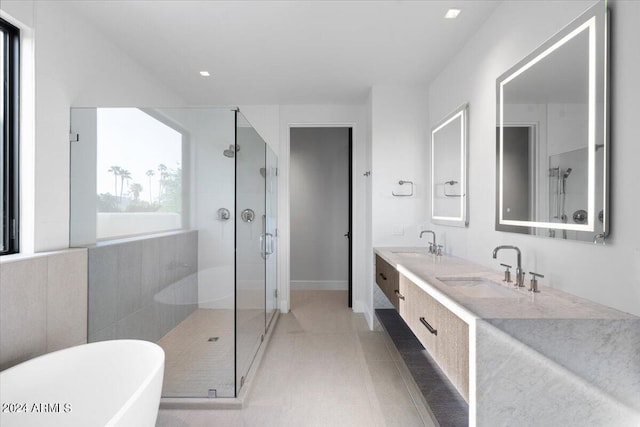 bathroom featuring tile patterned floors, vanity, and shower with separate bathtub