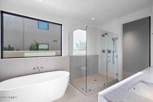 6311 E Phoenician Blvd Unit 21, Scottsdale, AZ 85251 - bathroom with a stall shower, a freestanding bath, vanity, and tile patterned floors