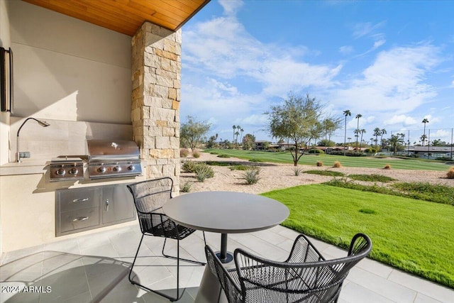 view of patio with an outdoor kitchen and a grill