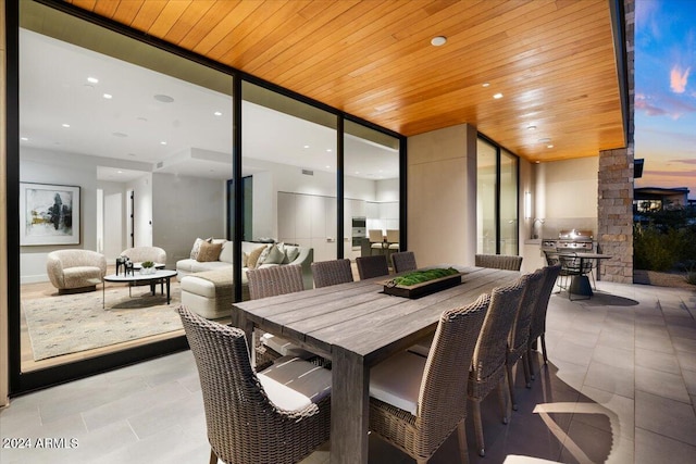 patio terrace at dusk featuring an outdoor hangout area