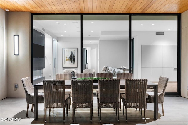 dining area featuring a wealth of natural light and wooden ceiling