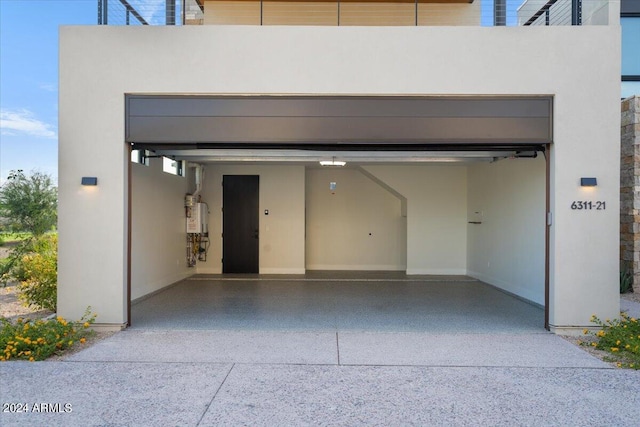 6311 E Phoenician Blvd Unit 21, Scottsdale, AZ 85251 - garage featuring concrete driveway and water heater