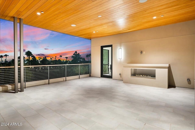 patio terrace at dusk with a fireplace