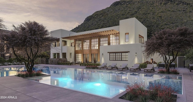 pool at dusk with a mountain view