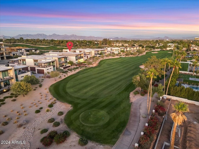 aerial view at dusk featuring a mountain view