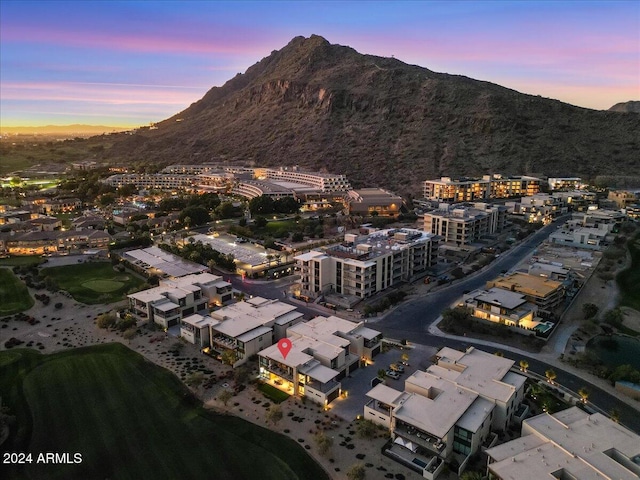 aerial view at dusk featuring a mountain view