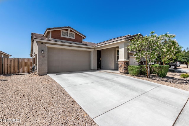 17171 W Tonto St, Goodyear, AZ 85338 - view of front of property featuring stucco siding, fence, concrete driveway, and a garage
