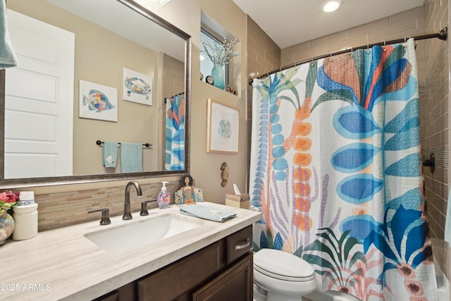 bathroom with tasteful backsplash, vanity, and toilet