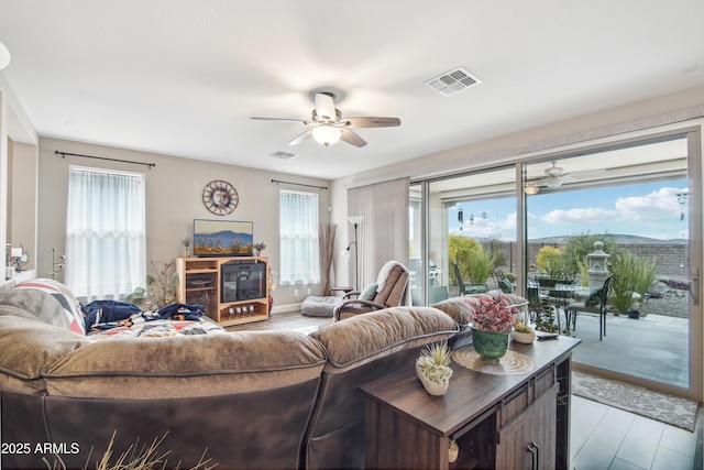 living room featuring plenty of natural light, light hardwood / wood-style floors, and ceiling fan